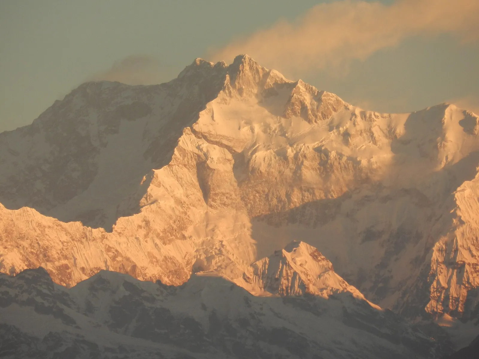 First sunlight on Kanchenjunga's summit, seen from Darjeeling